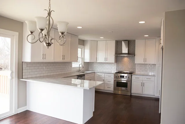 Modern kitchen with white cabinets, quartz counters, and center island